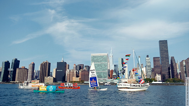 Das Bild zeigt das Werbefoto des Films: Eine Skyline im Hintergrund, davor Boote, die mit Schildern voller Klimaforderungen versehen sind. 